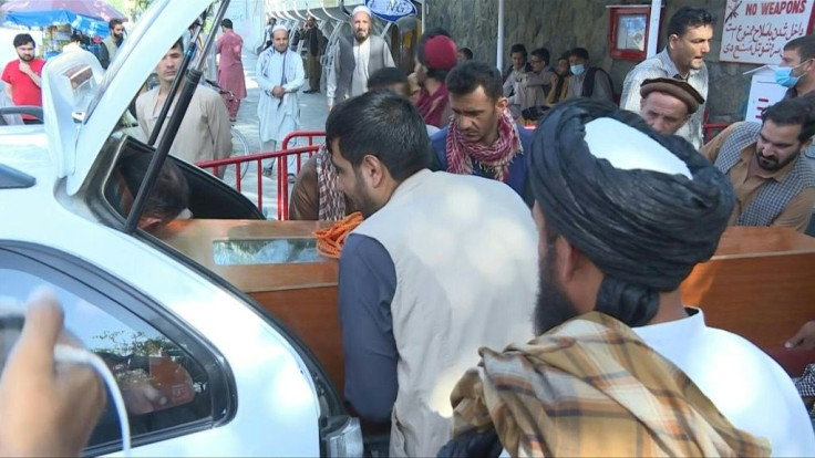 Family members Friday gather outside a hospital and collect bodies of their loved ones while others desperately seek information on missing relatives following the deadly twin blasts at Kabul airport."One of my brothers was at the airport. He wanted to 