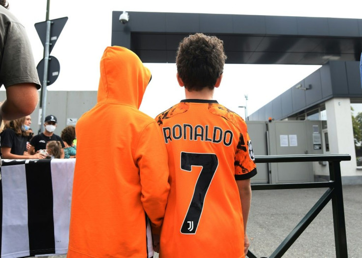 Juventuss fans wait for Cristiano Ronaldo outside the club's Continassa training centre in Turin on Friday