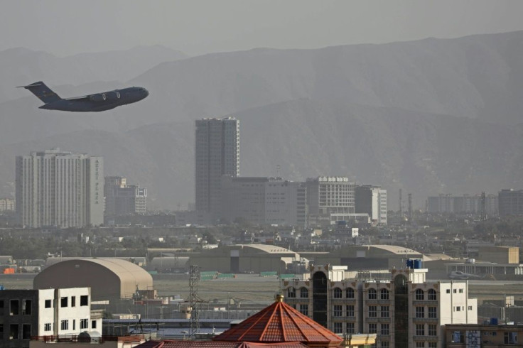 A US air force transport takes off from Kabul airport as the evacuation of tens of thousands continues despite an Islamic State suicide bombing that killed scores
