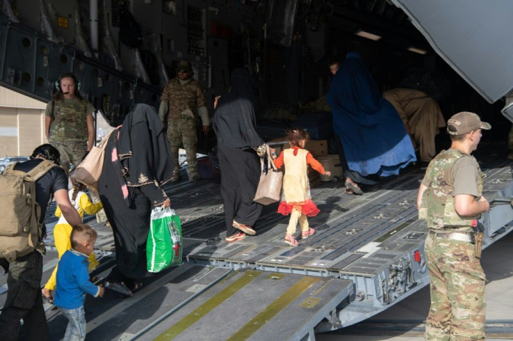Refugees from Afghanistan board a US Air Force transport at Kabul airport