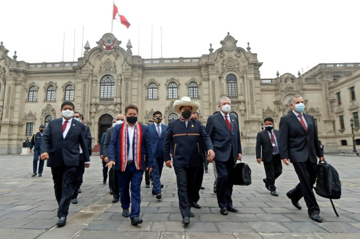 Peru President Pedro Castillo (center, wearing hat) accompanies his cabinet to congress awaiting a vote of confidence