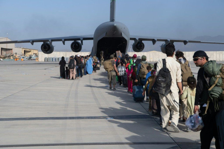 This handout photo courtesy ot the US Air Force shows passengers waiting to board a US air transport at Hamid Karzai International Airport (HKIA), Afghanistan, August 24, 2021