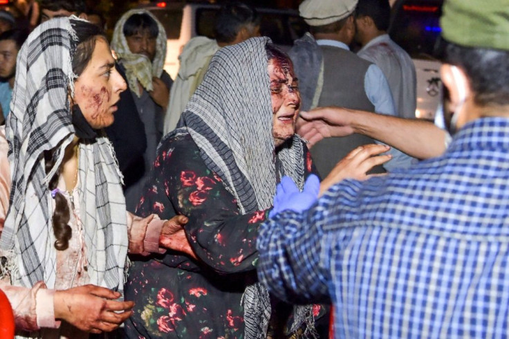Wounded women arrive at a hospital for treatment after a suicide attack in Kabul