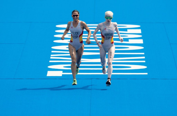 In this handout photo from the Olympic Information Services (OIS), Susana Rodriguez of Spain and her guide Sara Loehr approach the finish line