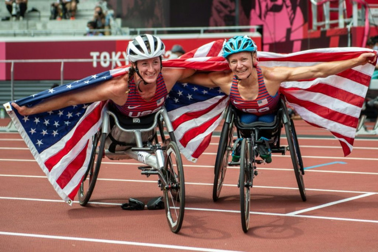 Tatyana McFadden (L) and Susannah Scaroni celebrate after winning bronze and gold, respectively, in the women's 5,000m T54