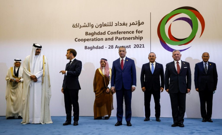 Leaders pose at a regional meeting in Baghdad