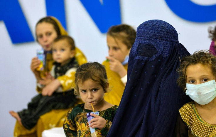 Refugees who fled Afghanistan after the Taliban takeover  gather at International Humanitarian City in the Emirati capital Abu Dhabi, as they wait to be transferred to another destination