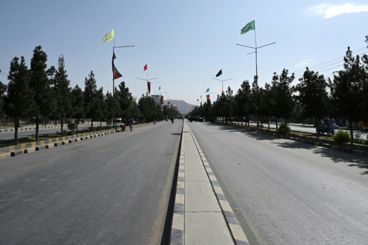A Taliban-captured Humvee blocks a deserted road leading to the airport in Kabul
