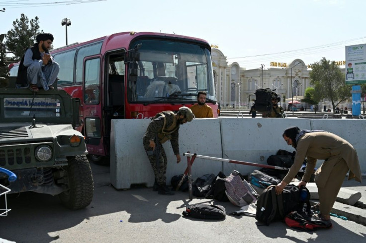 Taliban officials were ordering those destined for evacuation to leave their bags behind on the instruction of US troops, they said, but people were allowed to remove their valuables