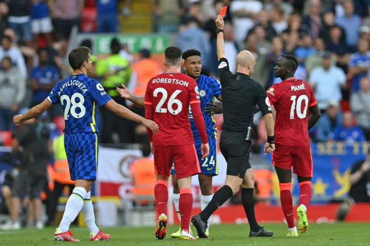 Anthony Taylor shows a red card to Chelsea defender Reece James