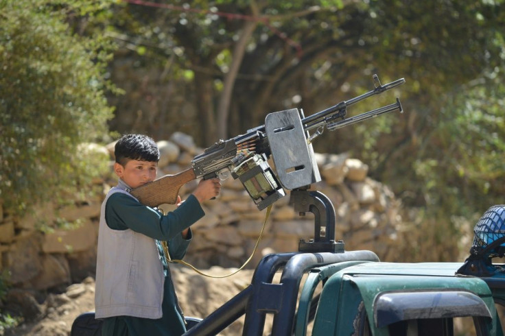 A boy holds a weapon on the back of a vehicle of anti-Taliban forces in Panjshir province on Saturday