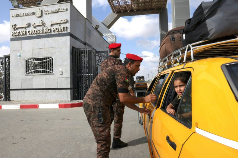 A Palestinian girl looks out a taxi window as she crosses with relatives into Egypt through the Rafah border crossing from the Gaza Strip on August 29, 2021