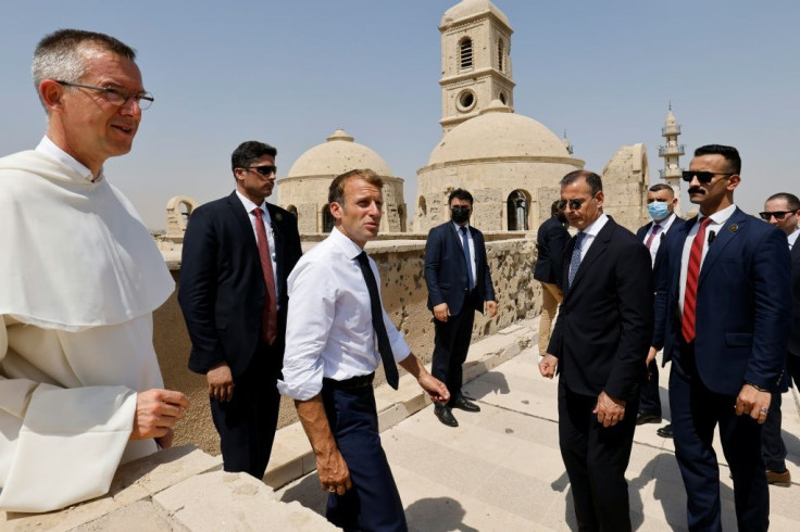 French President Emmanuel Macron (C) tours the Our Lady of the Hour Church in Iraq's second city of Mosul