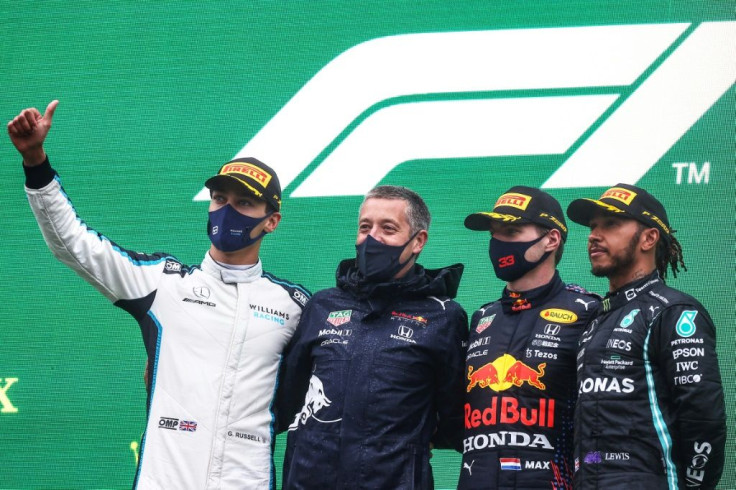 Russell with Verstappen (second right) and Hamilton on the podium