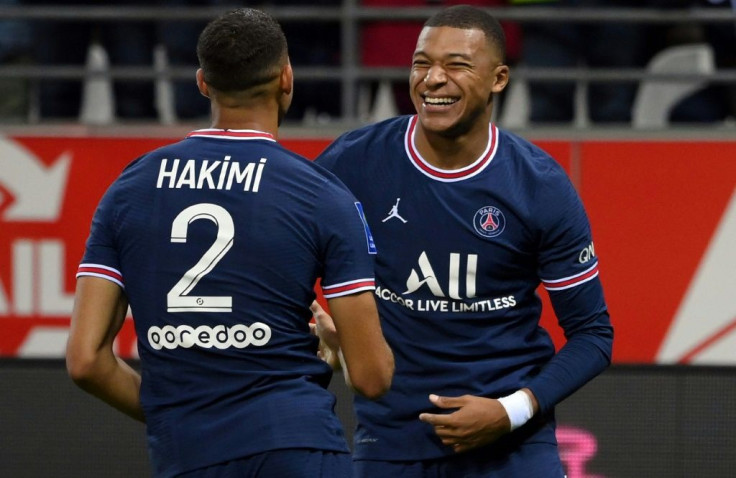 Kylian Mbappe celebrates with Achraf Hakimi after scoring PSG's second goal against Reims