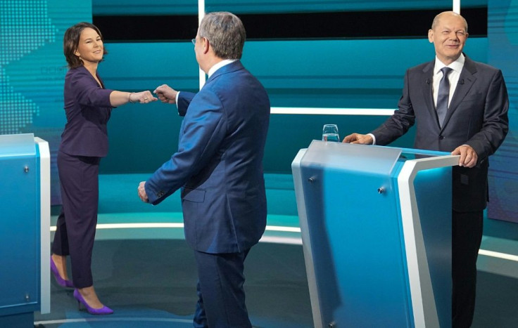 The candidates to become the next German Chancellor on the debate platform; Annalena Baerbock and Armin Laschet fist bump next to Olaf Scholz