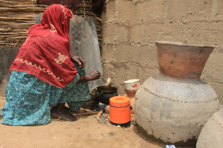 A woman cooks at the Yawuri camp on the outskirts of Maiduguri -- home to nearly 2,000 people displaced by the Boko Haram insurgency
