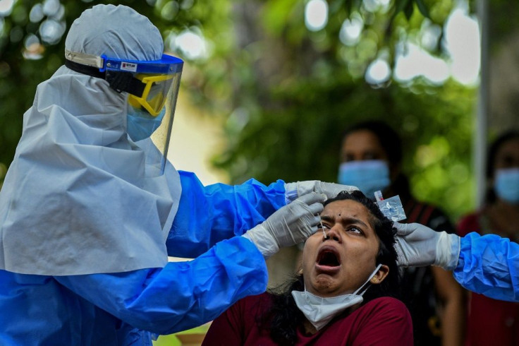 A health worker collects a  sample to test for the Covid-19 coronavirus in Colombo, Sri Lanka