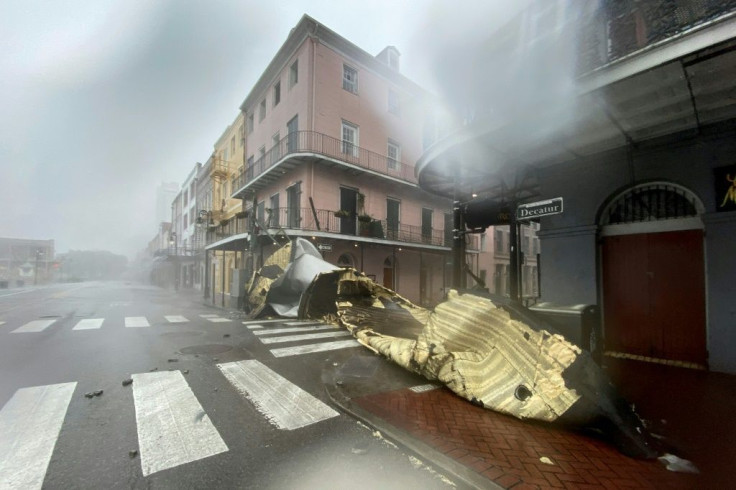 A section of a building's roof is blown off during rain and winds in the French Quarter of New Orleans on August 29, 2021