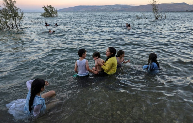 People swim in the Sea of Galilee (Lake Tiberias) near the Ein Gev kibbutz. Israel and Jordan recently agreed to their largest-ever water transaction