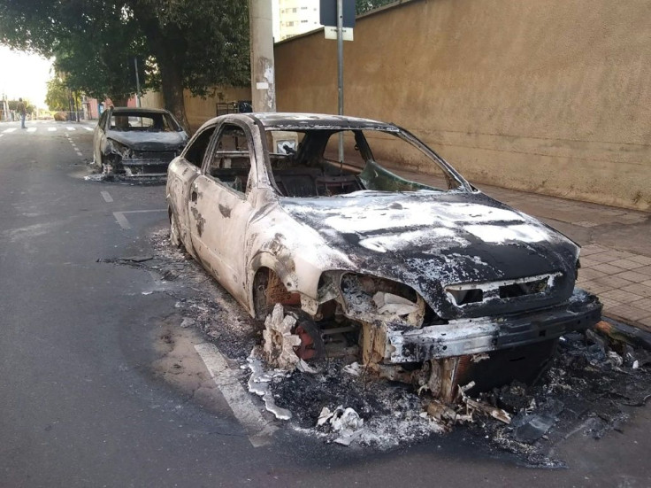 Cars burnt during a bank robbery are seen in Aracatuba, after a heavily armed group of bank robbers wreaked havoc