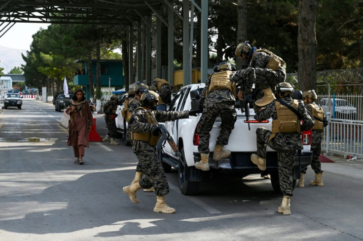 Taliban 'Badri 313' special force fighters arrive at the main entrance gate of Kabul airport after the last US troops left