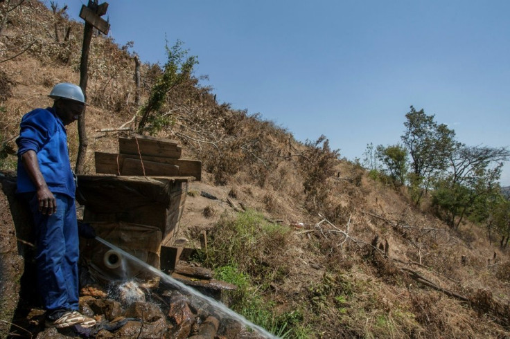 Green power: Colrerd Nkosi uses a pipe from a stream to drive a turbine salvaged from a piece of old farming equipment