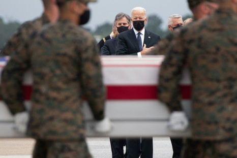 US President Joe Biden (C) attends the dignified transfer of the remains of service members killed during Kabul airport evacuation operatons at Dover Air Force Base in Dover, Delaware, on August, 29, 2021