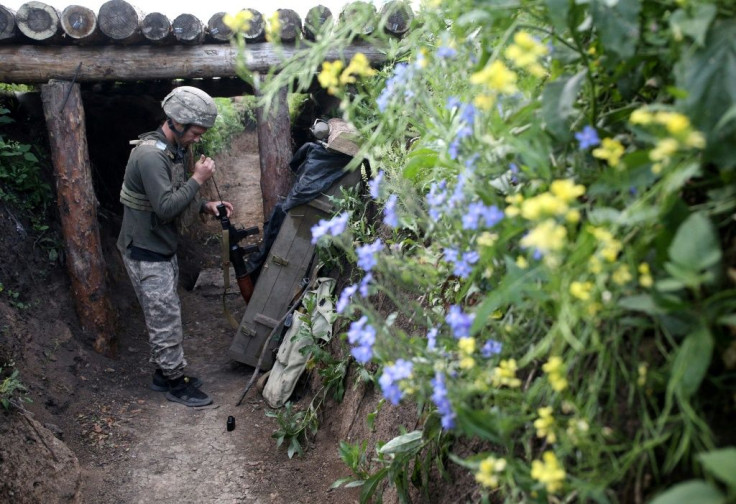 A Ukrainian serviceman cleans his machine gun on the frontline with Russia-backed separatists near small town of Volnovakha in the Donetsk region on June 23, 2021