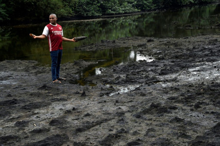 A resident stands in oil-polluted land in B-Dere, southern Nigeria