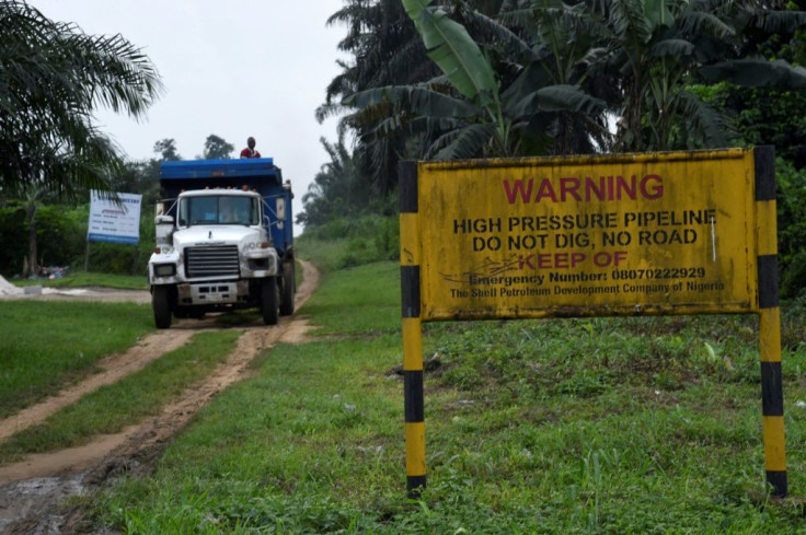 A truck drives along the path of a high pressure oil pipeline in Ejamah-Ebubu