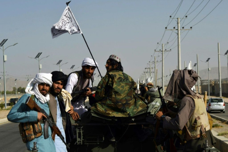 Taliban fighters stand on an armoured vehicle parading in Kandahar on September 1, 2021 to celebrate after the US pulled all its troops out of Afghanistan