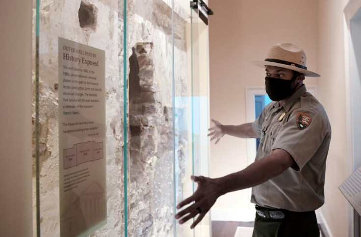 Park Ranger Aaron LaRocca shows an original wall from 1802 on display inside Arlington House