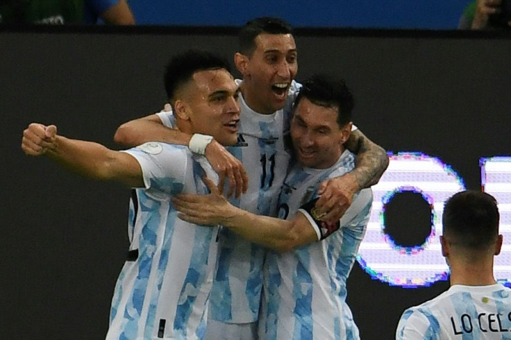 Lautaro Martinez (left) celebrates with his Argentina teammates Angel Di Maria (center) and Lionel Messi (right) after opening the scoring against Venezuela