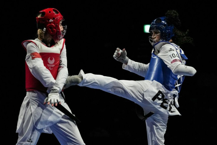 Peru's Leonor Espinoza Carranza (R) won taekwondo's inaugural gold in the women's K44 -49kg