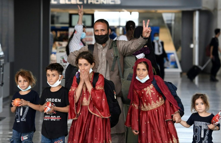 Afghan refugees arrive at Dulles International Airport on August 27, 2021 after being evacuated