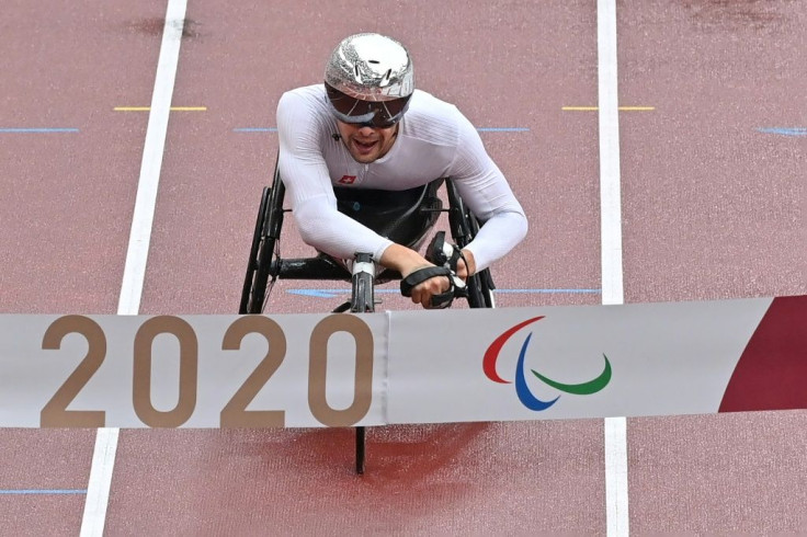 "Silver bullet" Marcel Hug crosses the finish line to win the men's marathon T54