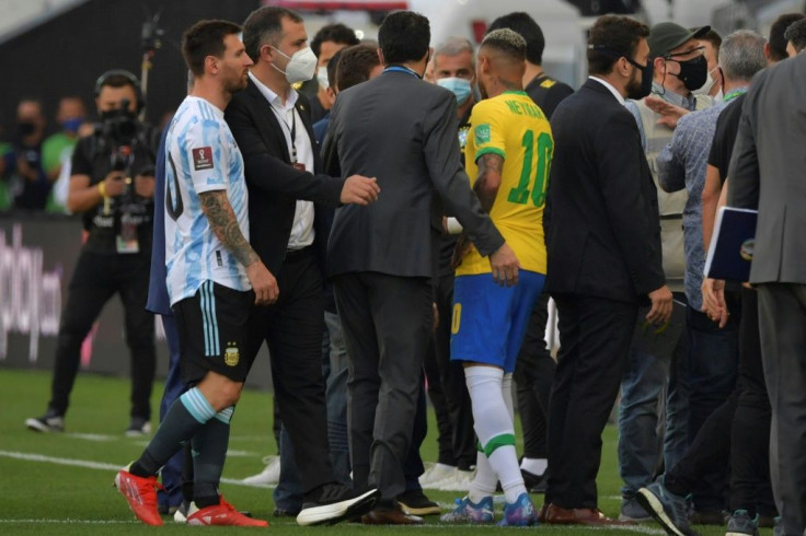 Argentina's Lionel Messi (L) and Brazil's Neymar are seen after the two teams' World Cup qualifier was halted by Brazilian health officials in Sao Paulo