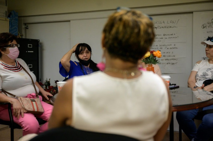 Lucelly Gil (center) at a support group for immigrants who helped clear rubble from the Twin Towers following the 9/11 attacks, in June 2021