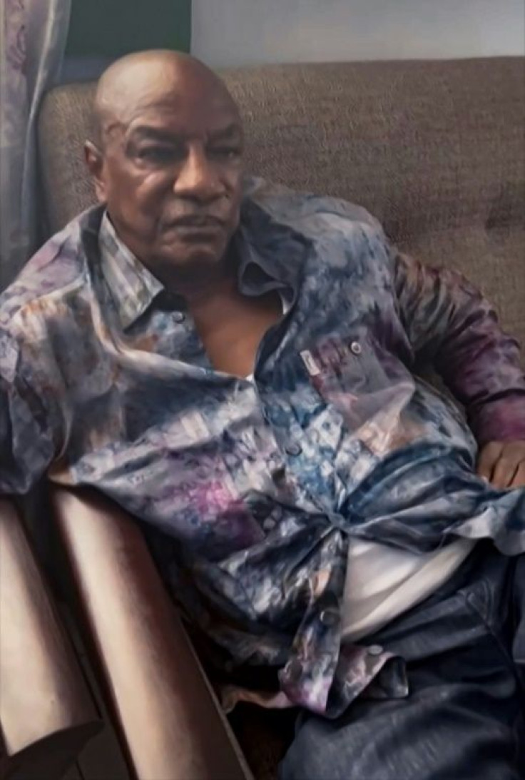 A screengrab from the video, in which Conde was seen sitting on a sofa with troops nearby