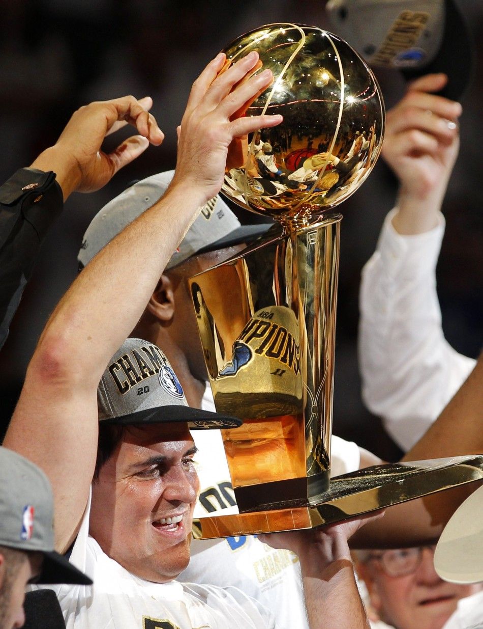 Dallas Mavericks owner Mark Cuban holds up the Larry O039Brien Championship Trophy after the Mavericks beat the Miami Heat in Game 6 to win the NBA Finals basketball series in Miami