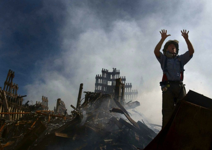 In this photo released by the US Navy on September 18, 2001, a New York City fireman signals to rescue workers making their way into the rubble that was  once the World Trade Center in New York City