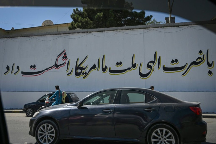 Many of Kabul's blast walls are now covered with Taliban propaganda slogans