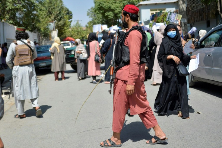 Taliban fighters kept watch throughout the protests