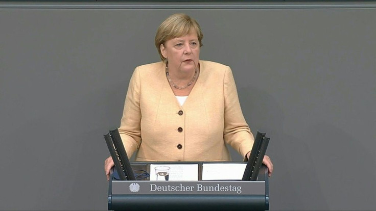 In parliament, German Chancellor Angela Merkel endorses Armin Laschet as the best choice to succeed her