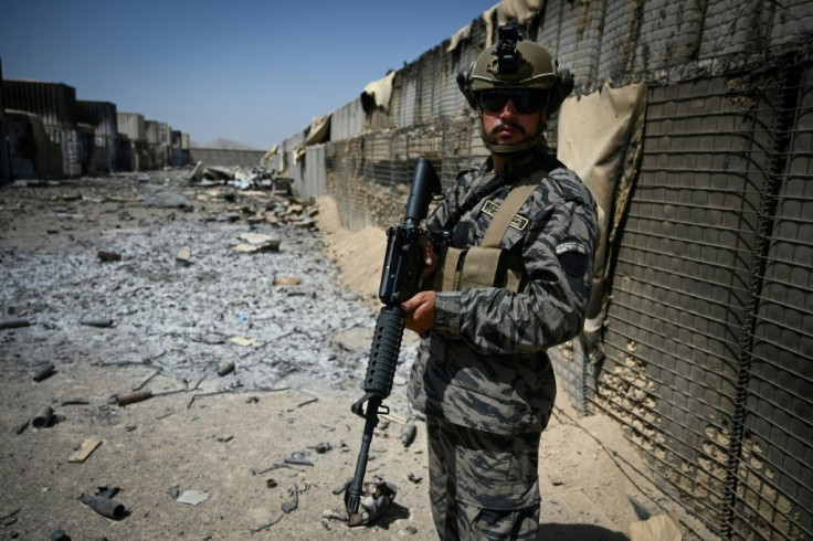 A Taliban Badri 313 unit officer stands guard at the destroyed CIA base in Deh Sabz District
