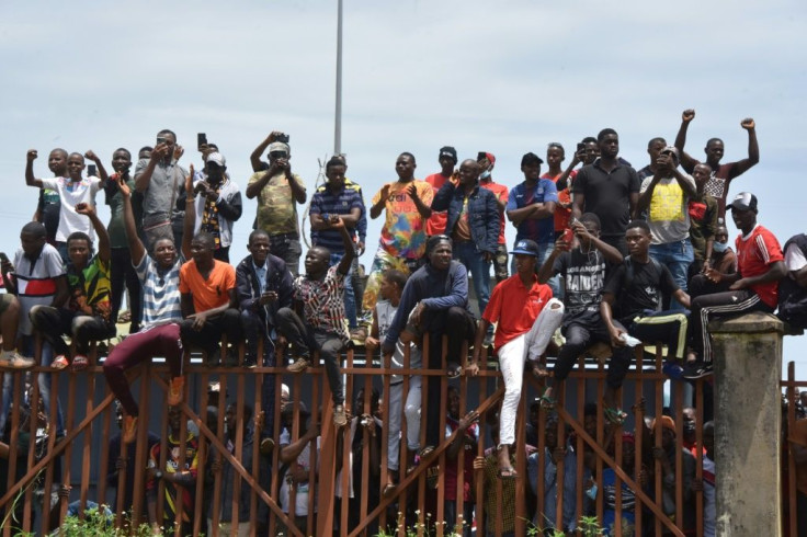 People celebrate as the coup leaders arrive at parliament for the Monday's meeting