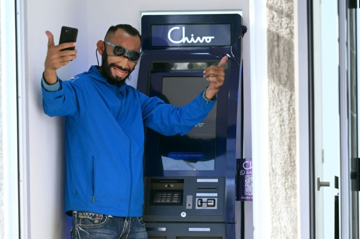 Special ATMs allow people to make bitcoin transactions and draw cash in dollars. This client is wearing a mask resembling President Nayib Bukele