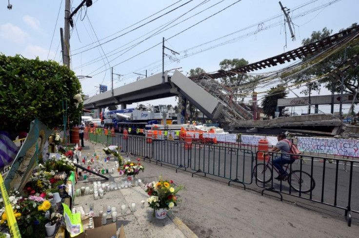 An altar with candles and flowers is seen near the section of an elevated track that collapsed bringing a train crashing down on May 3 in Mexico City