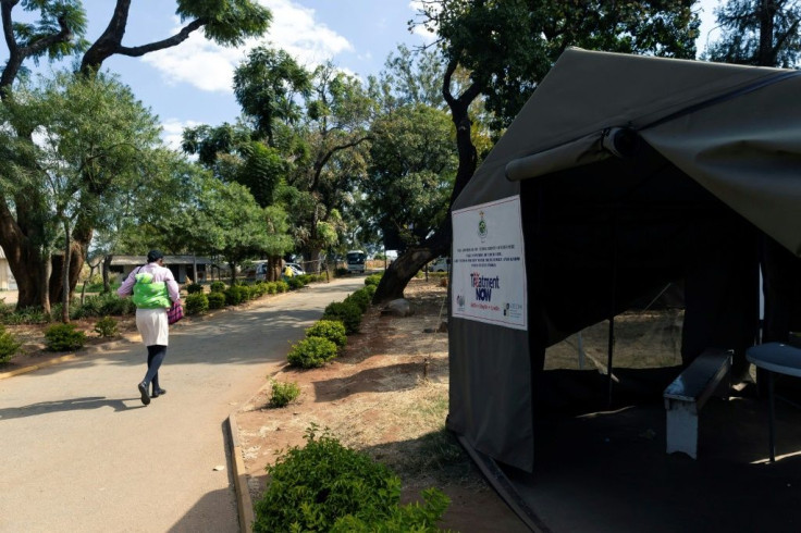 A patient walks past an HIV testing tent in Harare, Zimbabwe in June 2019